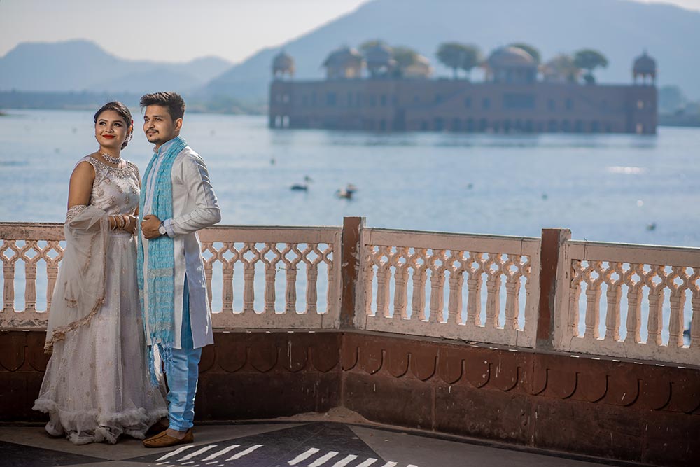 Bride in a traditional Rajasthani outfit posing at Jal Mahal for a pre-wedding shoot.