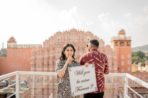 Couple posing in traditional Rajasthani attire during a pre-wedding photoshoot at a historic palace in Rajasthan, capturing the essence of romance and heritage.