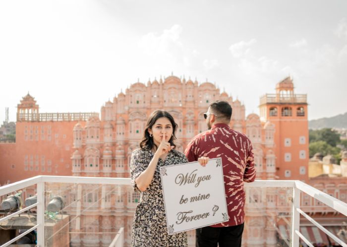 Couple posing in traditional Rajasthani attire during a pre-wedding photoshoot at a historic palace in Rajasthan, capturing the essence of romance and heritage.