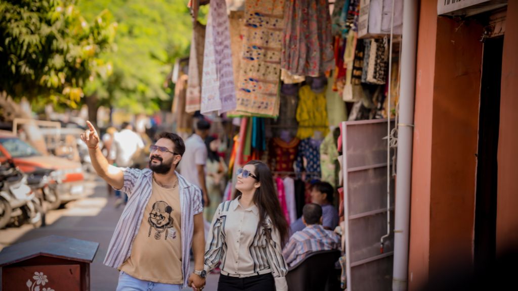 A couple strolling through the vibrant streets of Jaipur, enjoying the colorful surroundings in a pre-wedding shoot.