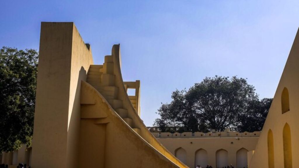 A unique architectural structure of the Jantar Mantar Observatory in Jaipur, showcasing large, geometric instruments against a bright blue sky Pre Wedding Shoot in Jaipur