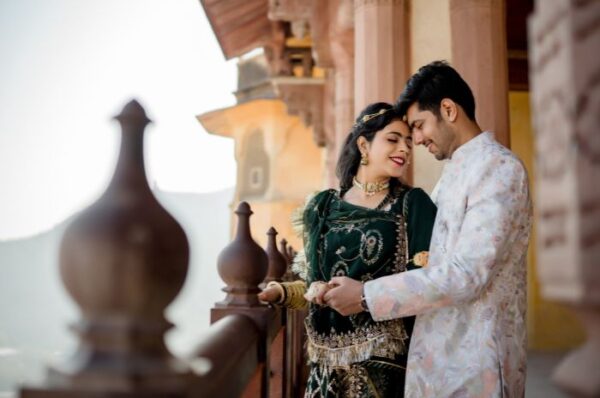 Couple posing in traditional Rajasthani attire during a pre-wedding photoshoot at a historic palace in Rajasthan, capturing the essence of romance and heritage."