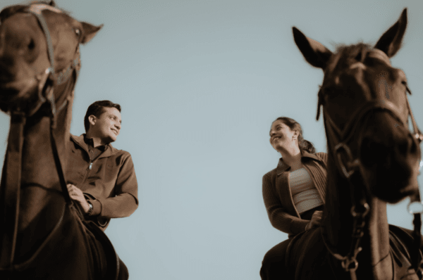 Couple posing with horses during a royal pre-wedding photoshoot in Jaipur
