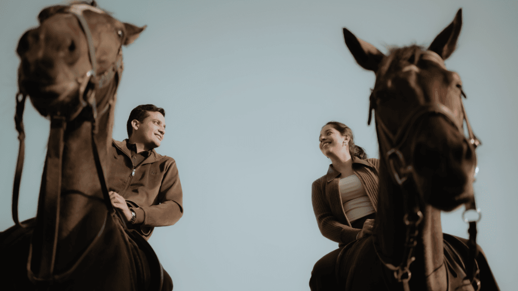 Couple posing with horses during a royal pre-wedding photoshoot in Jaipur