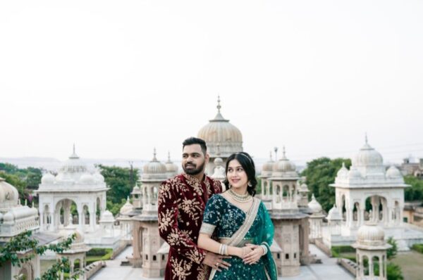 Pre-Wedding Shoot Locations in JaipurA couple dressed in traditional Indian attire posing romantically in front of the stunning architectural backdrop of Jaipur’s heritage monuments during their pre-wedding photoshoot.