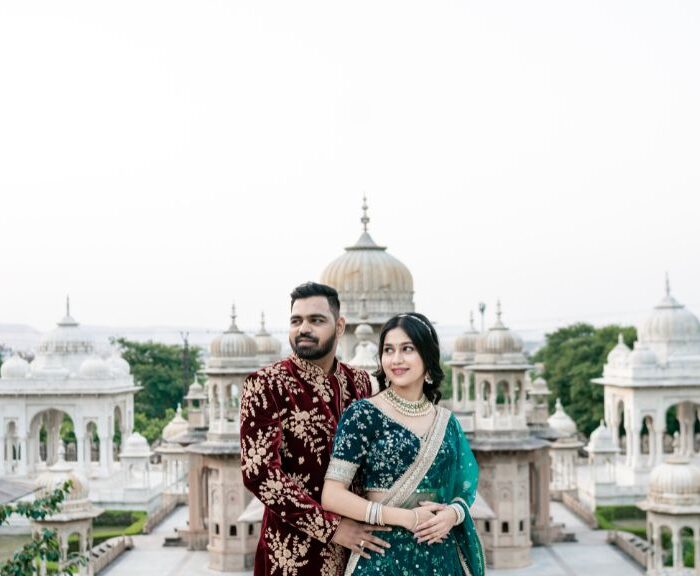 Pre-Wedding Shoot Locations in JaipurA couple dressed in traditional Indian attire posing romantically in front of the stunning architectural backdrop of Jaipur’s heritage monuments during their pre-wedding photoshoot.