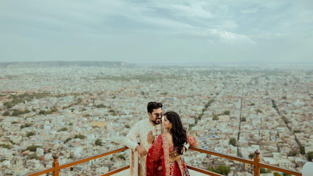 Couple sitting in a library-themed pre wedding photoshoot studio in Jaipur wearing coordinated outfits