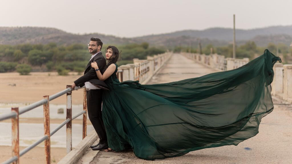 Couple posing romantically during golden hour on a bridge in Jaipur during their pre wedding shoot – ideal timing for soft lighting and stunning visuals.