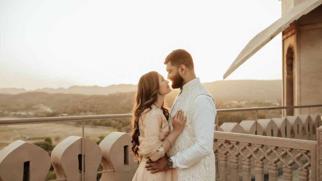 Couple posing on a bridge during golden hour with flowing dress, captured at perfect Pre Wedding Shoot Timing in Jaipur.