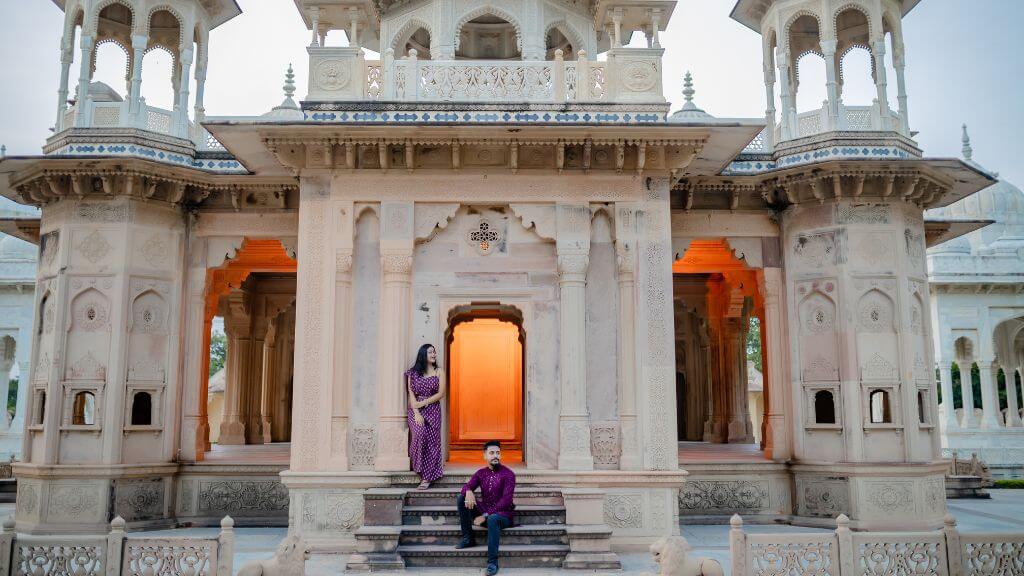 Couple in traditional attire posing at a royal heritage location in Jaipur at dusk, captured during the perfect Pre Wedding Shoot Timing in Jaipur.