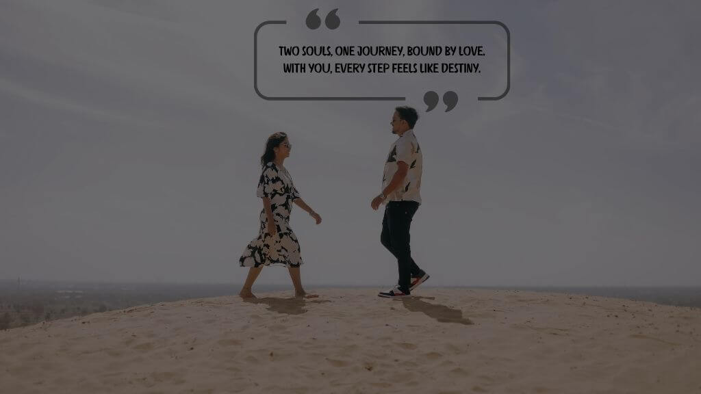 A couple walking toward each other on a sand dune under a clear sky, with a romantic quote overlay: “Two souls, one journey, bound by love. With you, every step feels like destiny.”